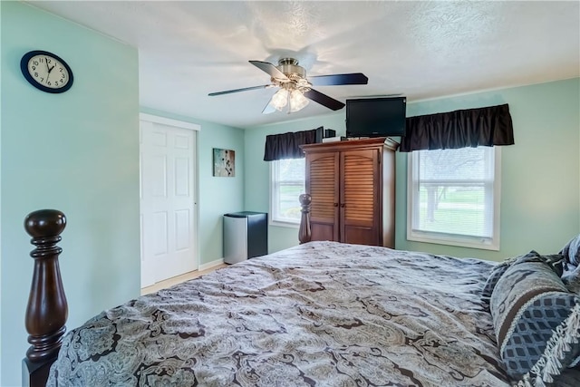 bedroom featuring baseboards and ceiling fan