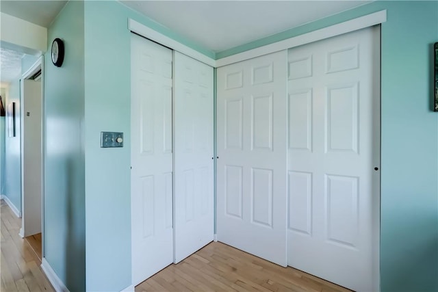 interior space featuring light wood-style floors and baseboards