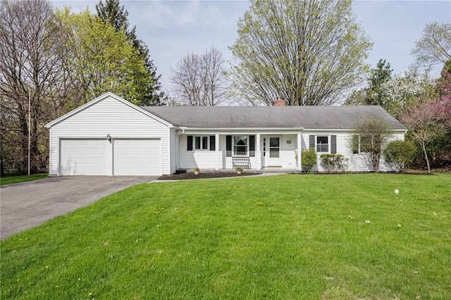ranch-style house featuring a porch, a chimney, a front yard, a garage, and aphalt driveway