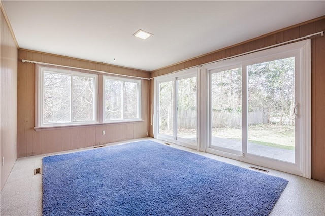 unfurnished sunroom featuring plenty of natural light and visible vents