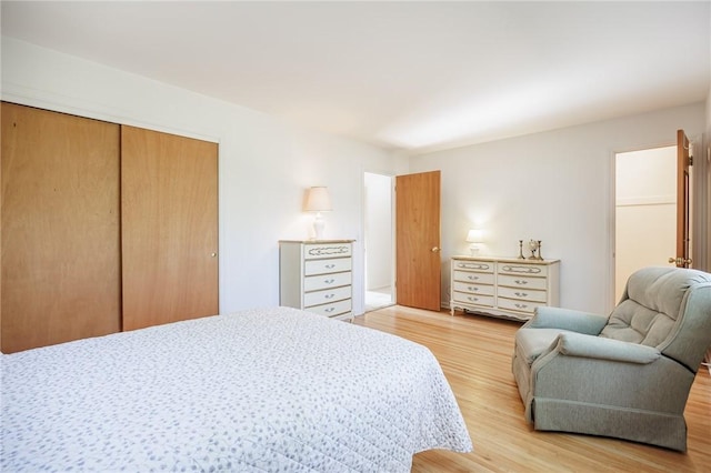 bedroom with a closet and light wood finished floors