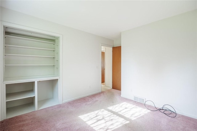 unfurnished bedroom with carpet flooring and visible vents