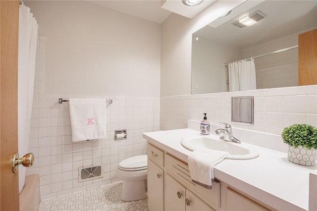bathroom featuring vanity, toilet, tile patterned floors, tile walls, and curtained shower
