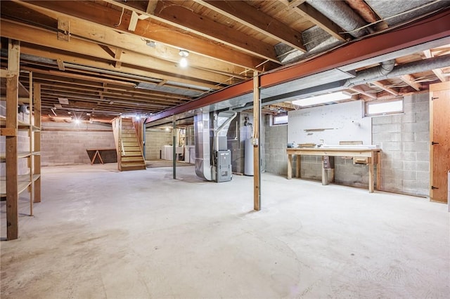 below grade area featuring heating unit, gas water heater, and stairway