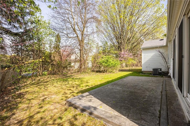 view of yard with central AC unit and a patio area