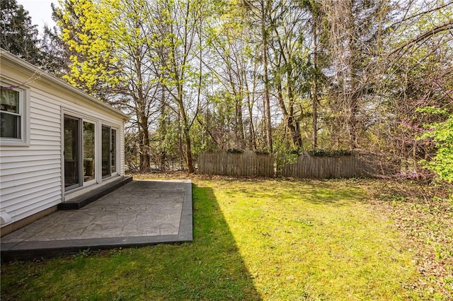 view of yard featuring fence and a patio area
