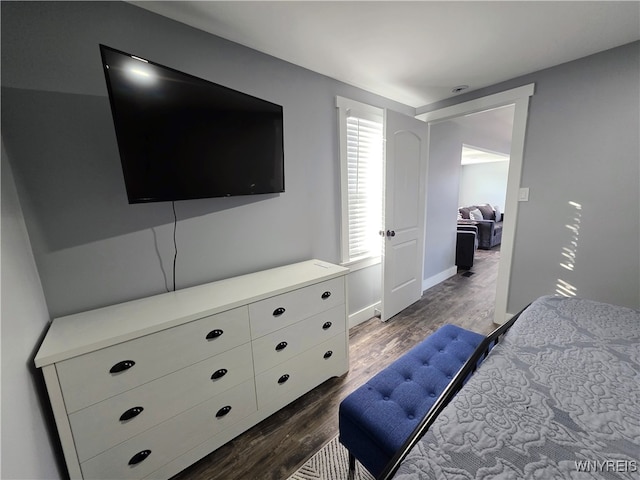 bedroom featuring baseboards and dark wood finished floors