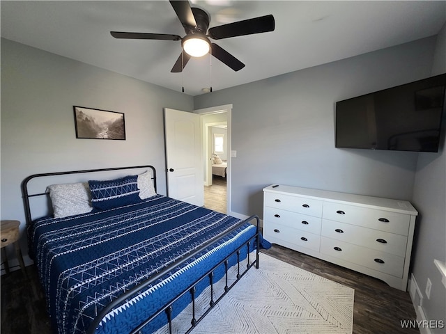 bedroom featuring baseboards, ceiling fan, and wood finished floors