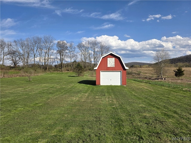view of barn featuring a yard and driveway