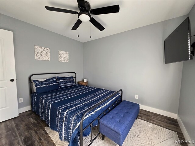 bedroom featuring baseboards, ceiling fan, and wood finished floors