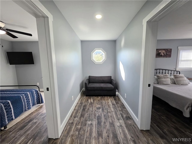 bedroom with baseboards and dark wood-style floors