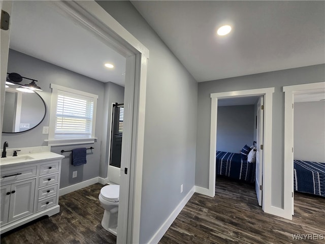 bathroom featuring baseboards, vanity, and wood finished floors