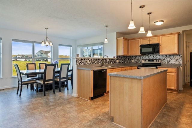 kitchen featuring decorative backsplash, a sink, black appliances, and a wealth of natural light