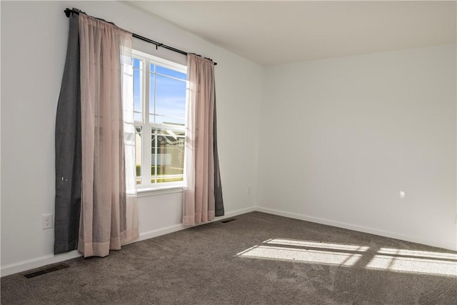 unfurnished room with baseboards, plenty of natural light, carpet flooring, and visible vents