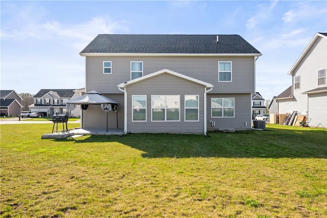 rear view of property with a residential view, a yard, a patio area, and cooling unit