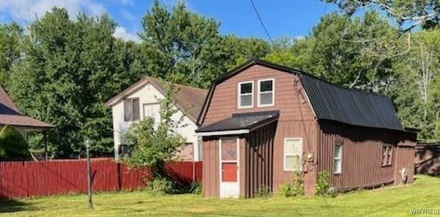 view of outbuilding featuring fence