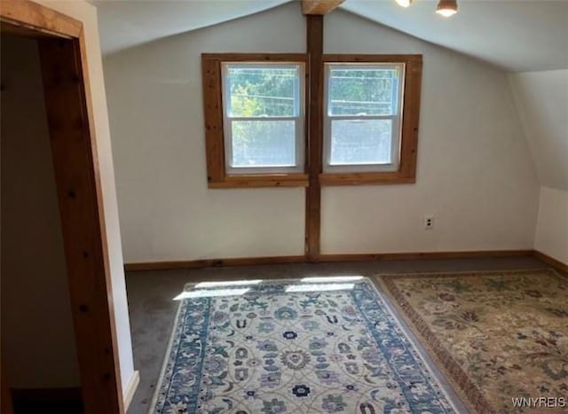 bonus room featuring baseboards and vaulted ceiling