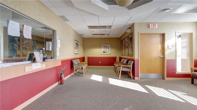 interior space with carpet floors, a paneled ceiling, and visible vents