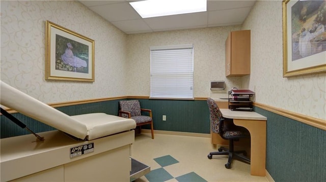 office area featuring tile patterned floors, wainscoting, and a paneled ceiling
