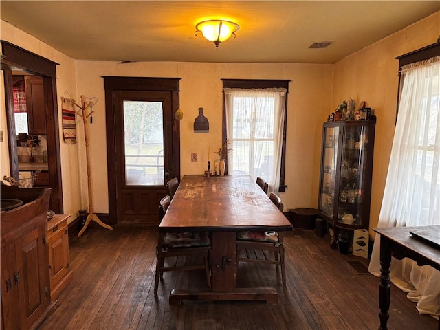 2384 State Highway 205, Laurens, NY 13810 - dining space with dark wood-type flooring, visible vents, and a wealth of natural light