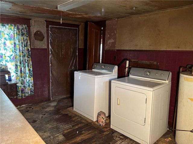 2384 State Highway 205, Laurens, NY 13810 - clothes washing area featuring laundry area, wainscoting, gas water heater, wood finished floors, and washing machine and dryer