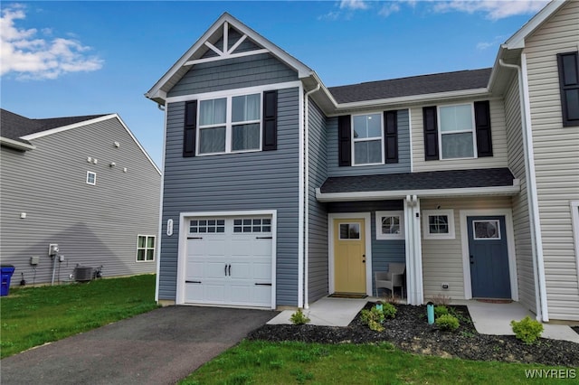 view of front of home with a garage, aphalt driveway, central air condition unit, and a shingled roof
