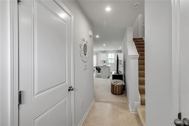 hall with stairs, recessed lighting, baseboards, and light tile patterned floors