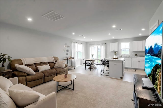 living room featuring visible vents and recessed lighting