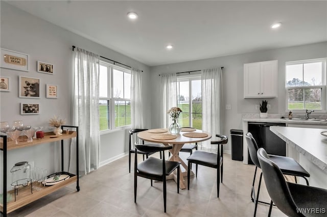 dining room featuring baseboards, recessed lighting, and a wealth of natural light
