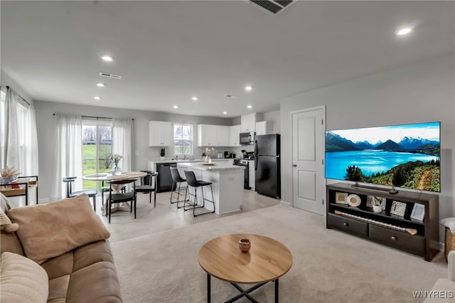 living area with visible vents and recessed lighting