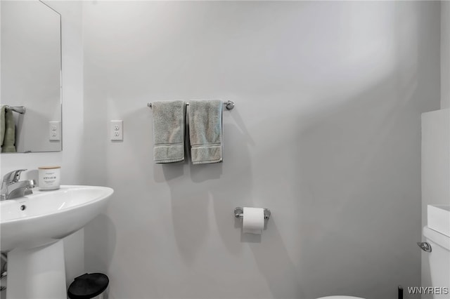 half bath featuring a sink and toilet