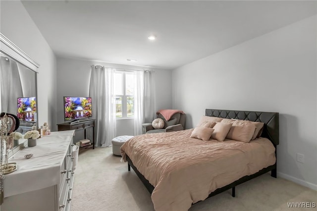 bedroom featuring light colored carpet and baseboards