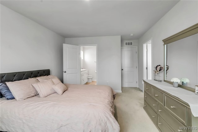 bedroom with visible vents, connected bathroom, baseboards, and light colored carpet