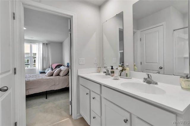 ensuite bathroom featuring double vanity, a sink, and ensuite bath