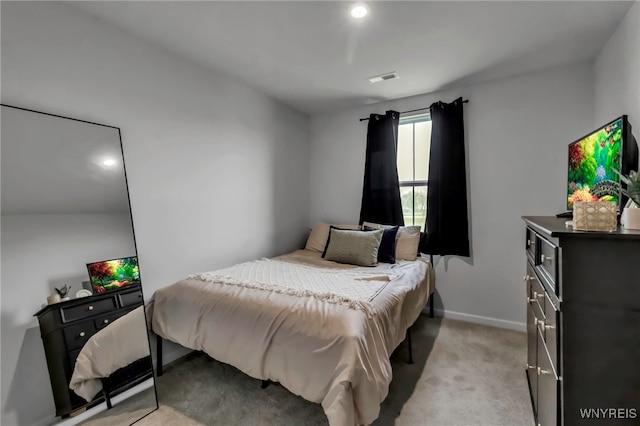 bedroom with light colored carpet, baseboards, and visible vents