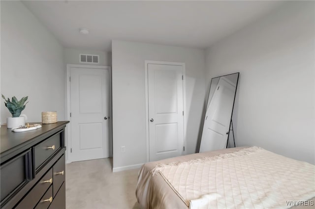bedroom featuring visible vents, baseboards, and light carpet