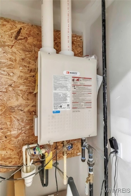 utility room featuring water heater