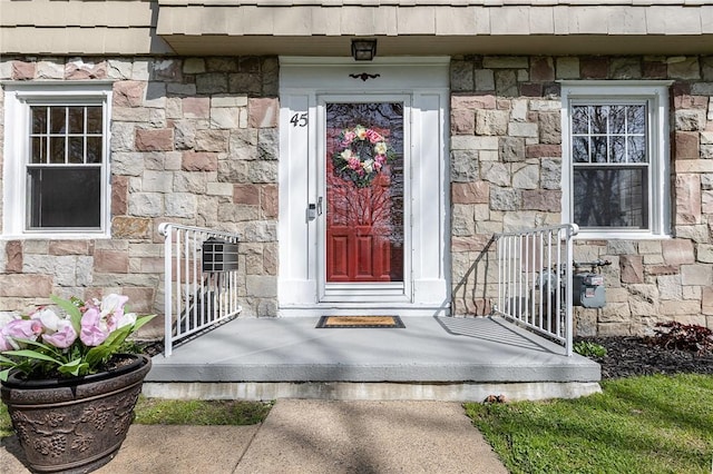 doorway to property with stone siding