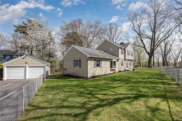 view of side of home with a garage, a fenced backyard, and a lawn
