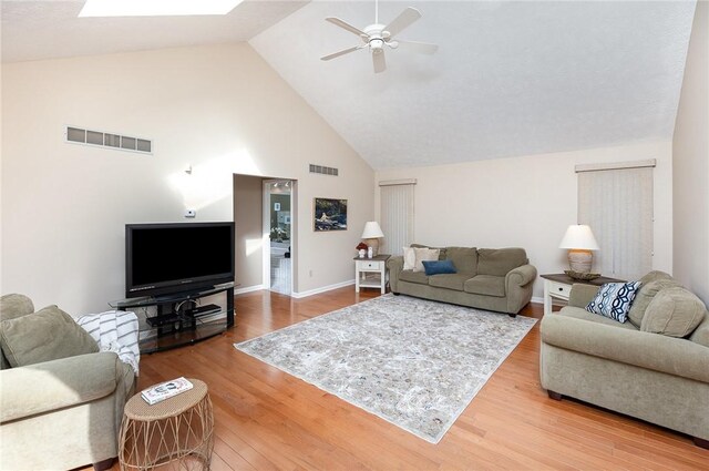 living room with visible vents, a ceiling fan, wood finished floors, and high vaulted ceiling