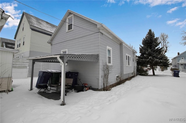 view of snow covered rear of property