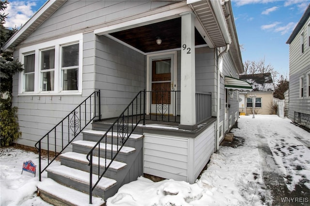 view of snow covered property entrance