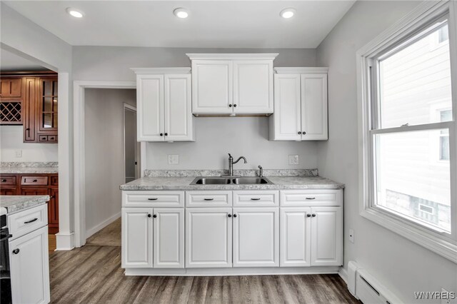 92 Carlyle Ave, Buffalo, NY 14220 - kitchen with baseboard heating, light wood-style floors, light countertops, plenty of natural light, and recessed lighting