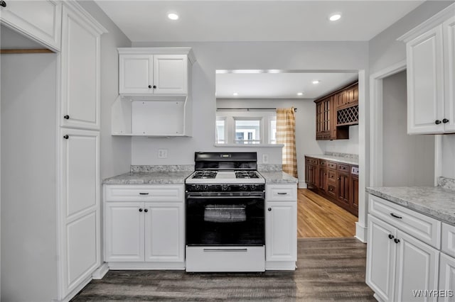 92 Carlyle Ave, Buffalo, NY 14220 - kitchen with white range with gas cooktop, dark wood-style floors, white cabinets, recessed lighting, and light stone countertops