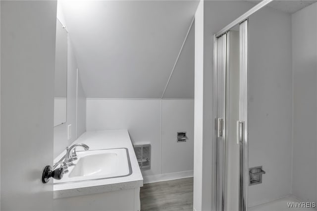 full bath with vanity, visible vents, wood finished floors, baseboards, and a shower with shower door