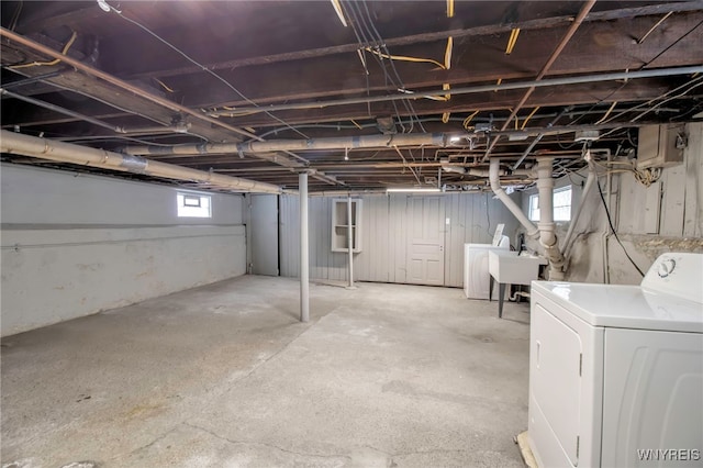 basement with a sink and washer / clothes dryer