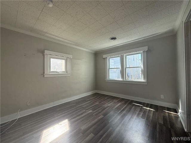 unfurnished room with crown molding, dark wood-style flooring, visible vents, and a healthy amount of sunlight