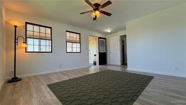 unfurnished bedroom with baseboards and wood finished floors