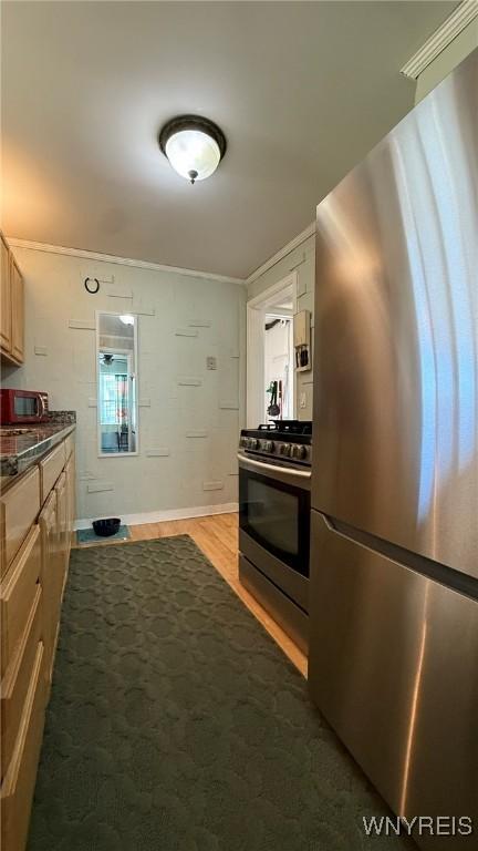 kitchen with dark countertops, stainless steel appliances, and dark wood-style floors