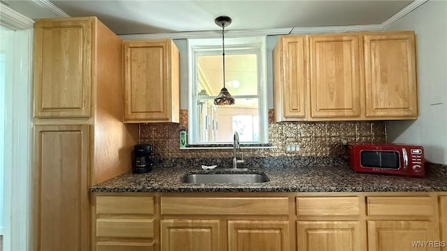 kitchen with backsplash, a sink, and light brown cabinets